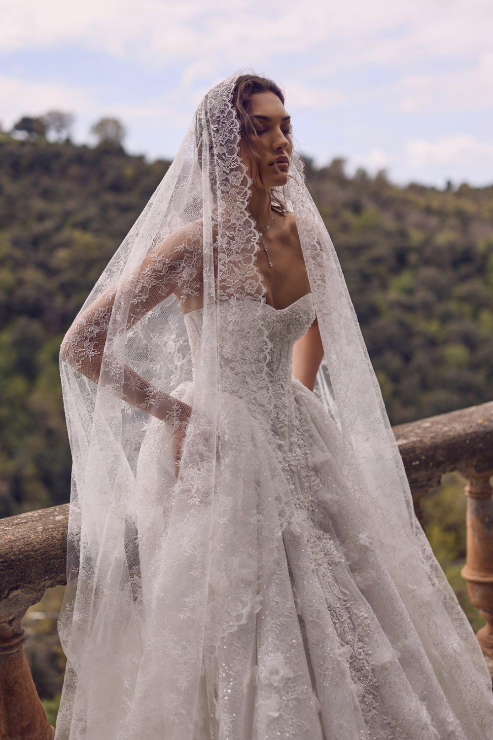 Bride wearing a modern lace wedding dress with sheer lace sleeves