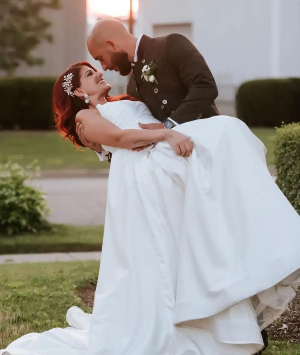 Сouple wearing a white gown and a black suit